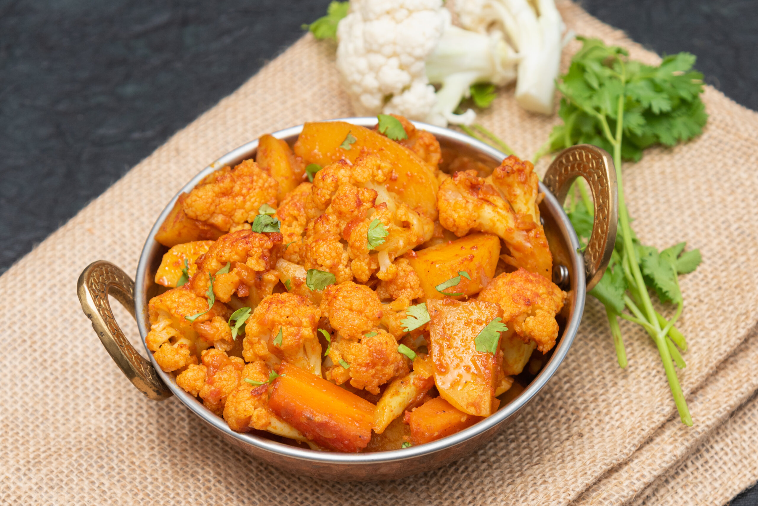 aloo gobi indian curry dish with potatoes and cauliflower. sabzi potatoes with cauliflower, indian style vegetable curry. traditional north indian vegetarian curry dish