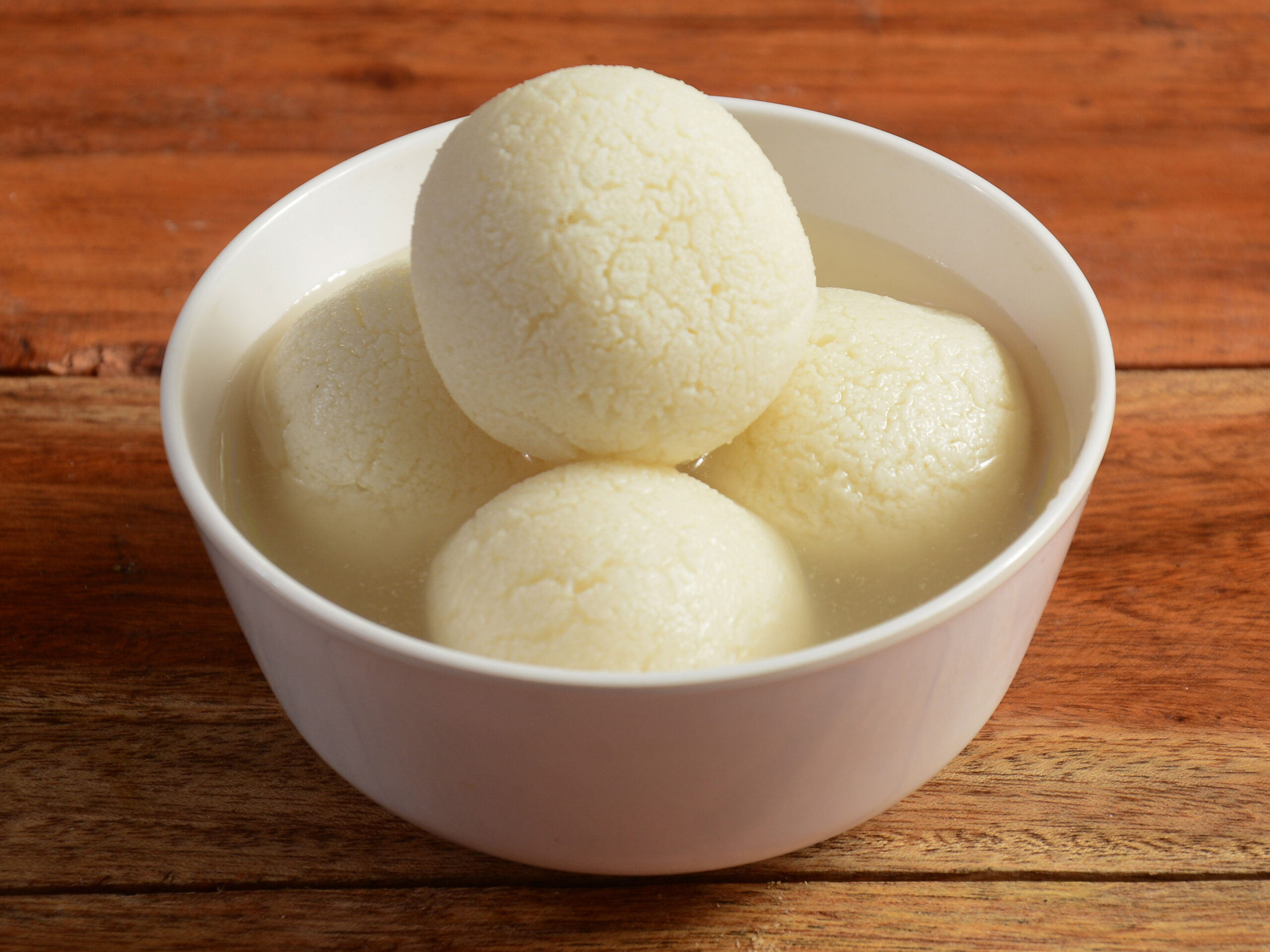 indian rasgulla or dry rosogulla dessert / sweet served in a bowl. selective focus