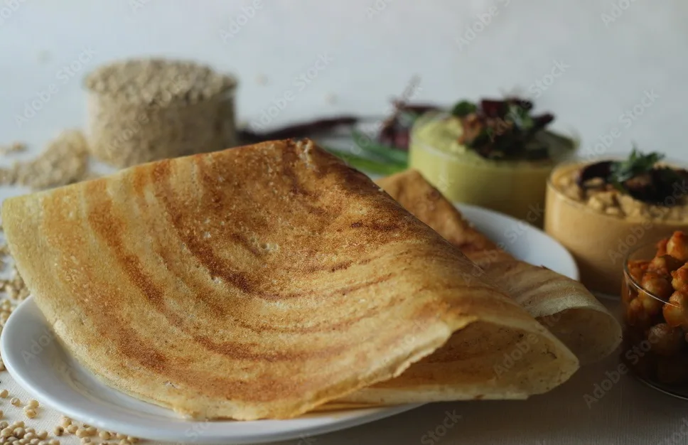 sorghum pancakes. crispy pancakes made of whole grain sorghum and lintels. popularly known as jowar dosa. served with chickpea masala and condiments