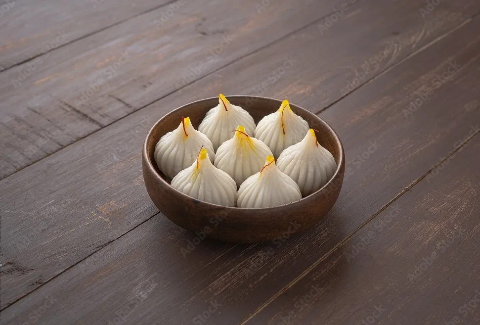 steamed modak, ukdiche modak, white modak made from rice flour and coconut jaggery filling. modak is a traditional indian sweet made during ganesh utsav and also offered to lord ganesha