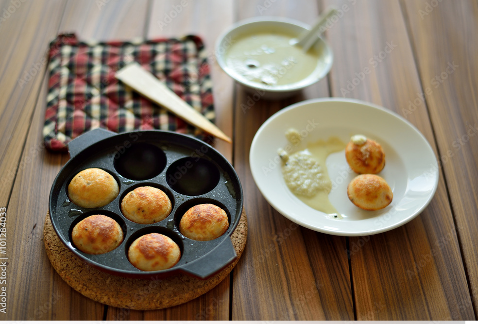 hettinad or chettinadu kuzhi paniyaram alongside an appe pan