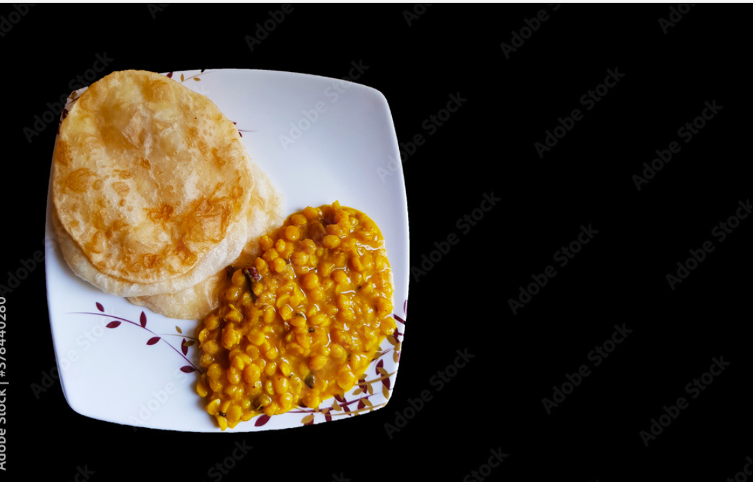 plate having luchi and cholar dal gram gravy