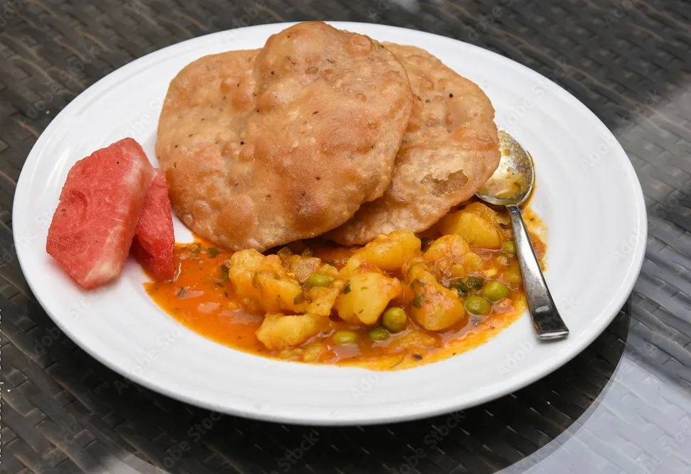 bedmi puri with aloo ki sabzi potato curry, top view of traditional indian breakfast recipe in jaipur, rajasthan,