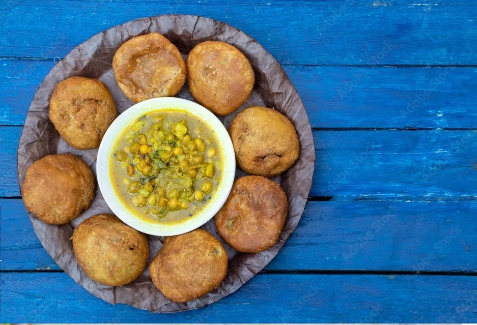 khasta kachori or kachodi with curried yellow peas or ghugni curry