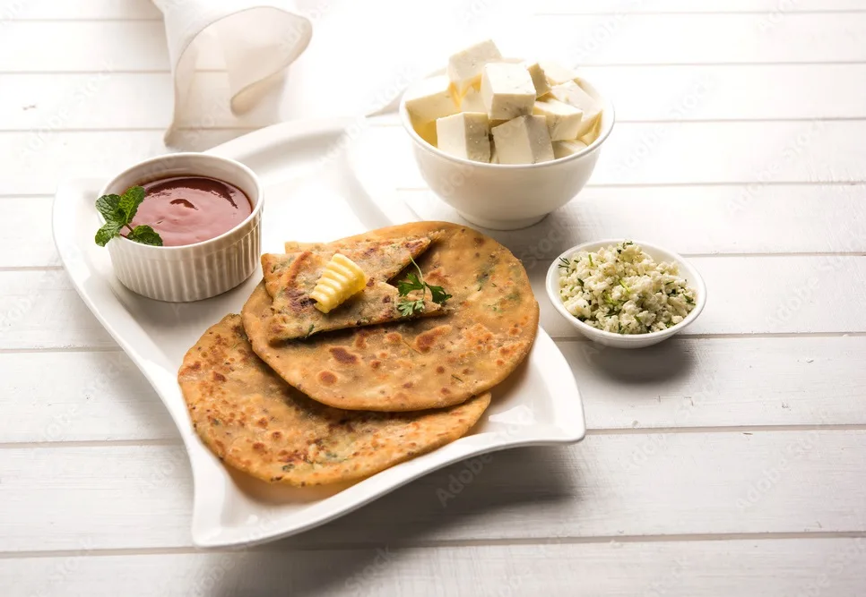 stuffed paneer paratha with melting butter, served with fresh cottage cheese cubes