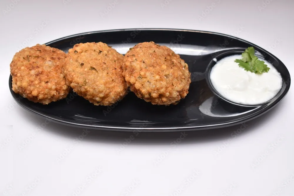 sabudana wada or shabudana vada called in india made from sago and served with curd garnished by coriander