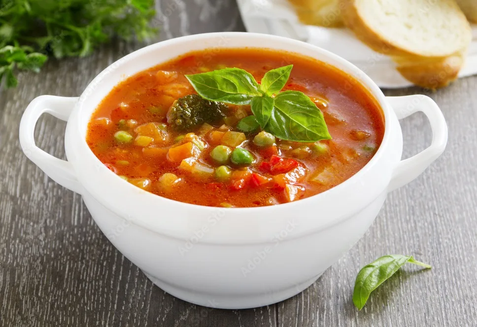 bowl of minestrone soup with bread