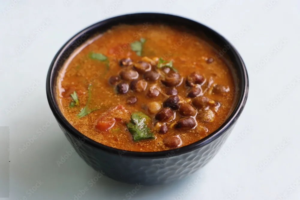 kalya vatanyachi usal, kala vatana sambar or aamti, curry made with dried black peas in gravy with roasted coconut, onion and spice