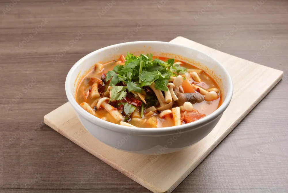 hot and spicy tom yum soup with mushroom and mixed vegetables