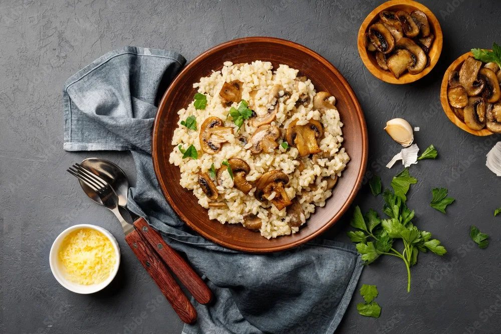 a dish of italian cuisine risotto from rice and mushrooms