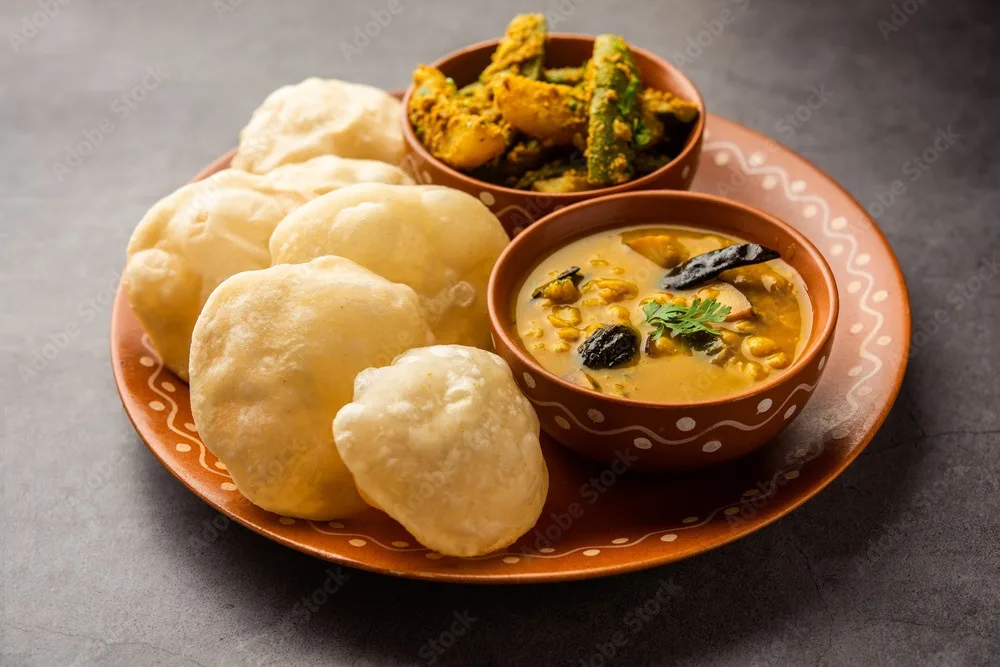 cholar dal and patol aloo sabzi served with fried luchi